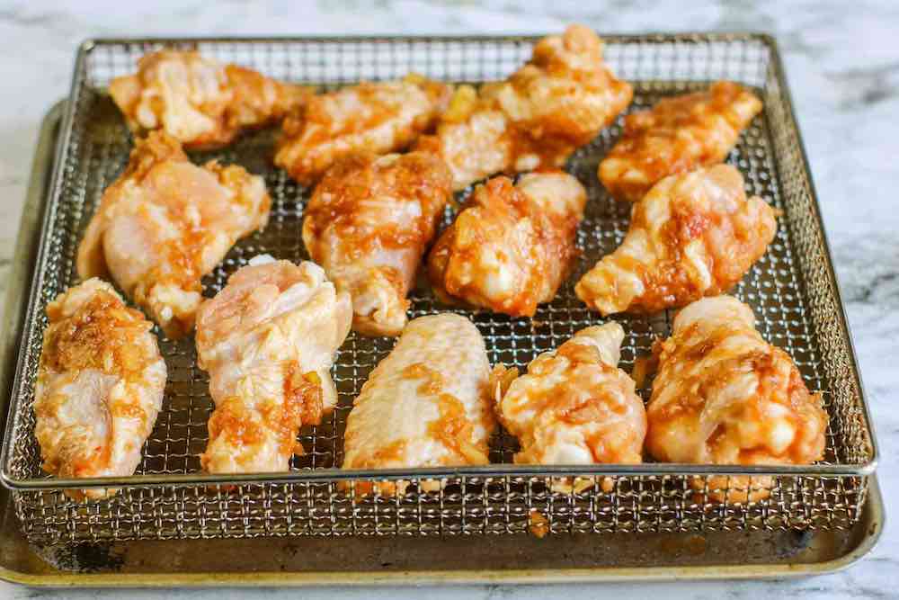 Air Fryer Hawaiian BBQ Chicken Wings Recipe featured by top Hawaii blogger, Hawaii Travel with Kids: Place the marinated chicken wings on the air fryer basket