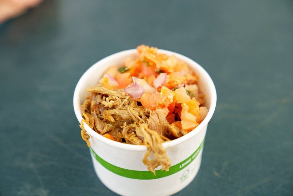 There are so many awesome Kauai food trucks to try! Image of a cup of kalua pork, lomi lomi salmon, and poi from Hanalei Taro and Juice Co Kauai food truck