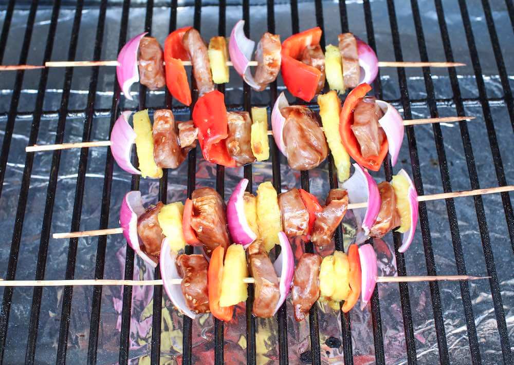 Pu tthe Hawaiian BBQ beef skewers on the grill