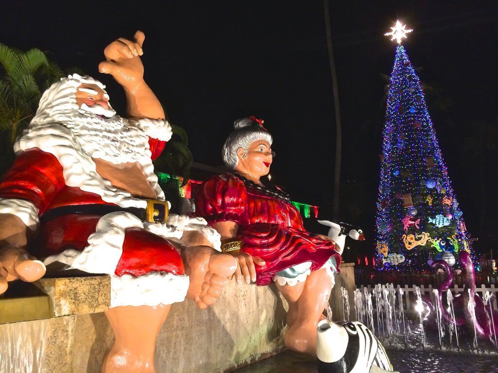 You'll definitely want to check out Honolulu City Lights when heading to Hawaii in winter. Image of a huge Santa and Mrs. Claus in Hawaii