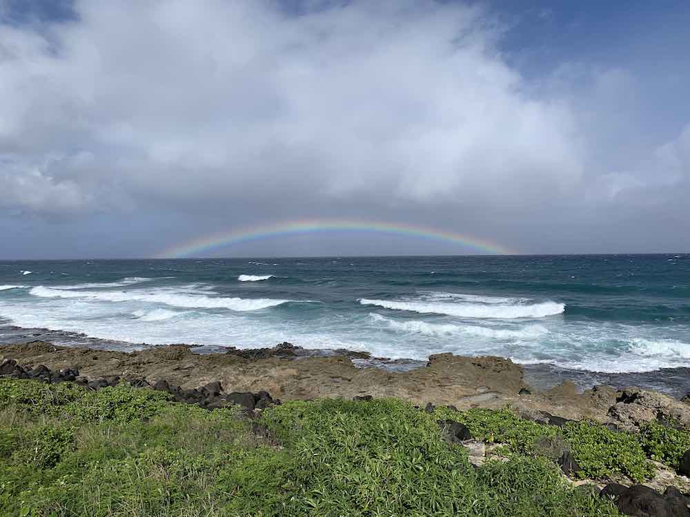 Kaena Point Hike guide featured by top Hawaii blogger, Hawaii Travel with Kids: Image of a rainbow at Kaena Point Oahu 