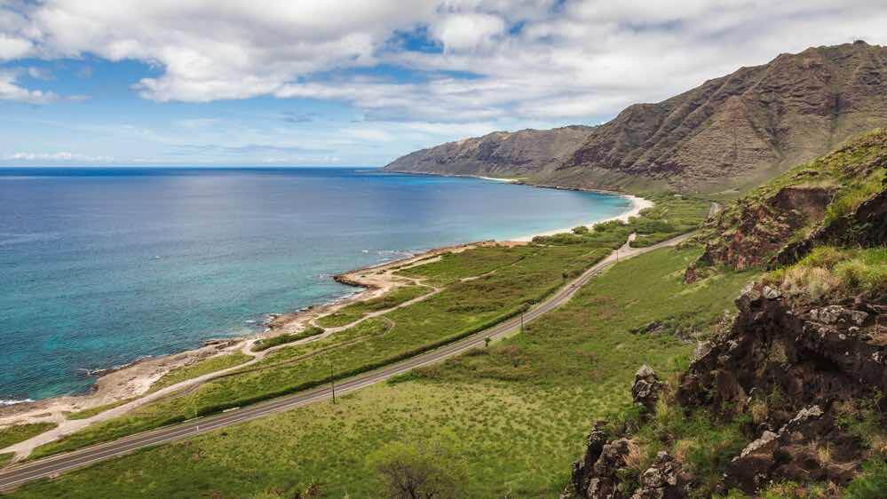 Kaena Point Beach scenic seascape and road seen from the ridge on the west side of Oahu, Hawaii, USA.