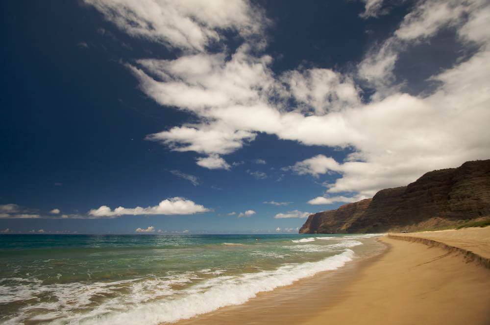 One of the best places to watch a Kauai sunset is Polihale Beach. Image of Polihale Beach on Kauai, Hawaii