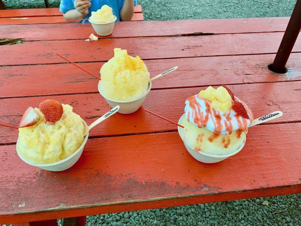 Some of the best Kauai food trucks offer authentic shave ice. Image of 3 shave ice bowls from Wailua Shave Ice.