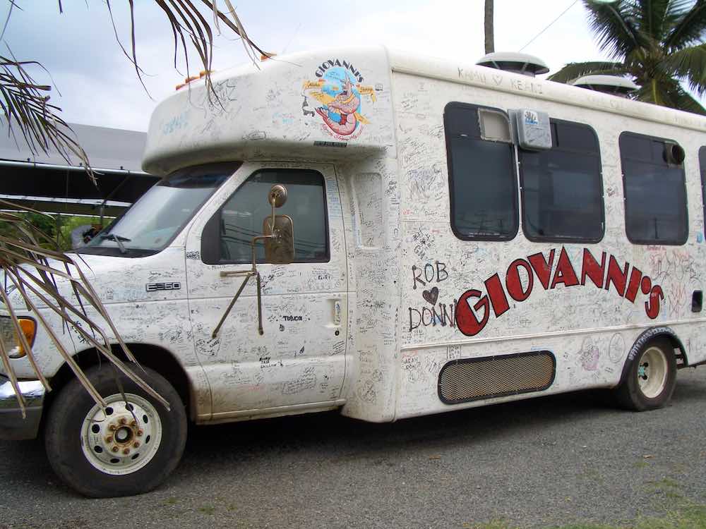 Giovanni's is one of the best North Shore food trucks. Image of Giovanni's Shrimp Truck on North Shore Oahu covered in signatures. 