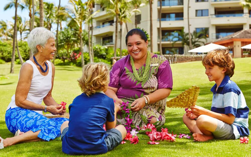 Best Maui Resorts for Families: Where to Stay on Maui with Kids featured by top Hawaii blog, Hawaii Travel with Kids: https://hawaiitravelwithkids.com/wp-content/uploads/2020/11/lei-making-hero.jpg