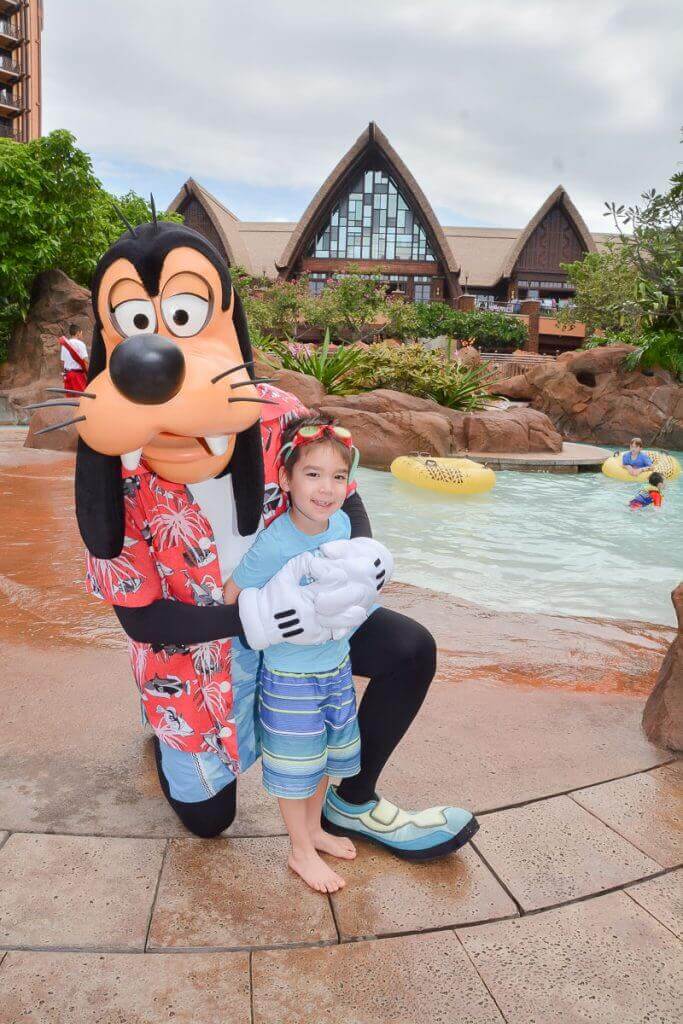 Image of a boy posing with Goofy at Disney Aulani Resort in Hawaii