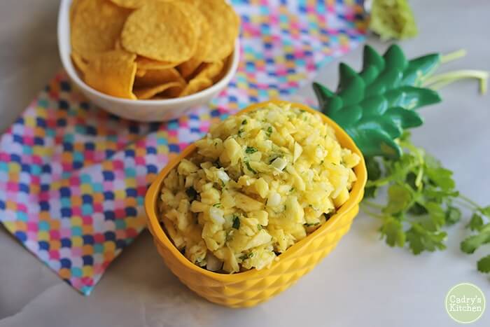 Learn how to make fresh pineapple salsa. Image of pineapple salsa in a pineapple dish.