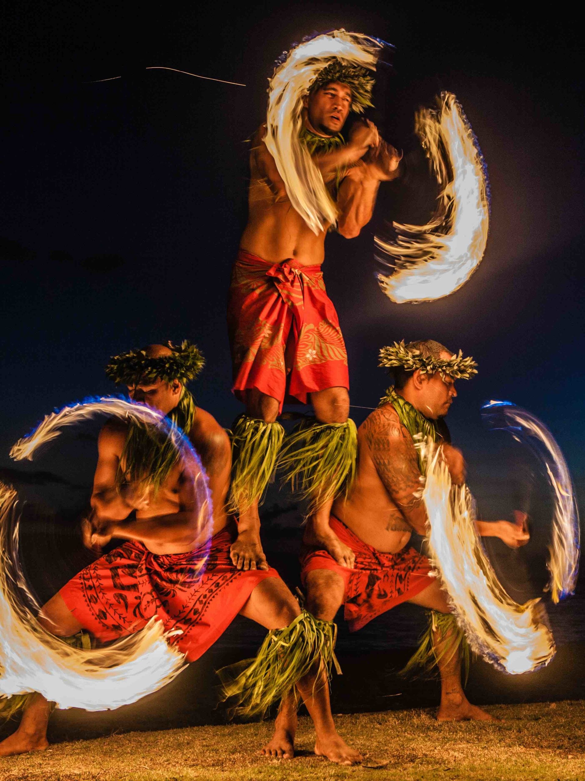 Find out the best Big Island luaus by top Hawaii blog Hawaii Travel with Kids. Image of Hawaiian fire dancers on the beach.