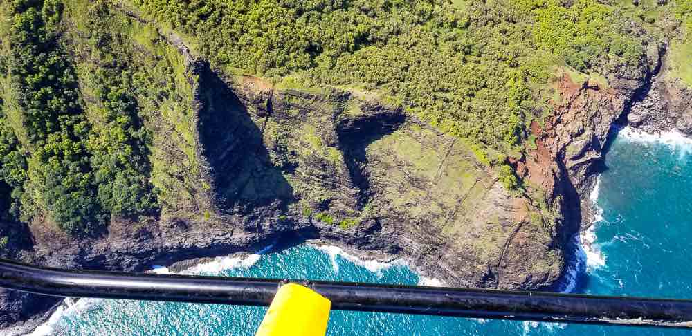 Doors off helicopter Kauai tour image of the Na Pali Coast.