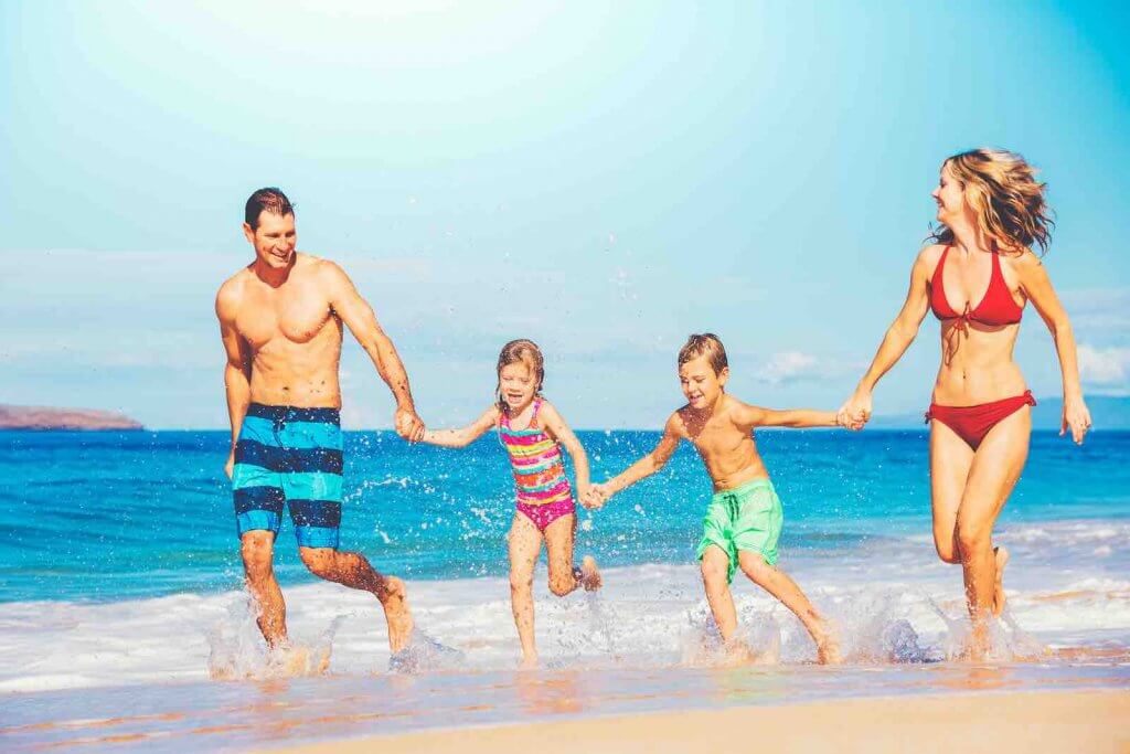 Find out the best 5 days in Maui interary for families from top Hawaii blog Hawaii Travel with Kids. Image of: Happy family having fun on beautiful warm sunny beach.