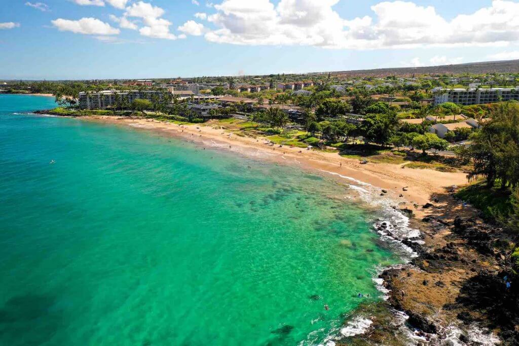 Image of green ocean water next to a golden beach