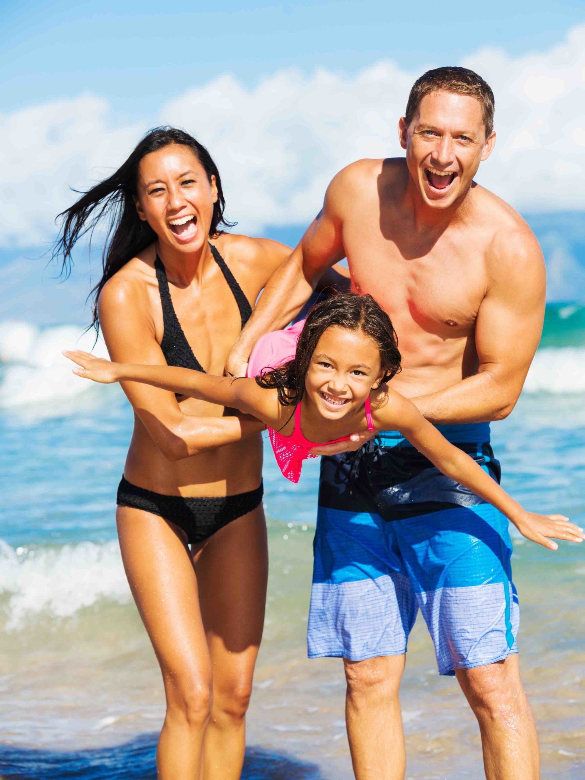 Find out all the best things to do on Oahu with kids by top Hawaii blog Hawaii Travel with Kids. Image of a young happy playing on the beach in Hawaii.