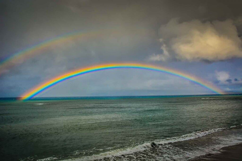 Image of a double rainbow over Kahana Beach in Maui