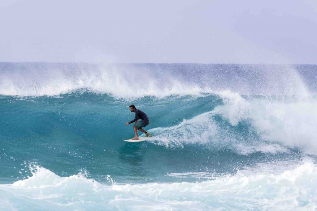 Image of A surfer riding barrels of the Banzai Pipeline, a very popular pro-surf spot at the Northshore region of O’ahu.