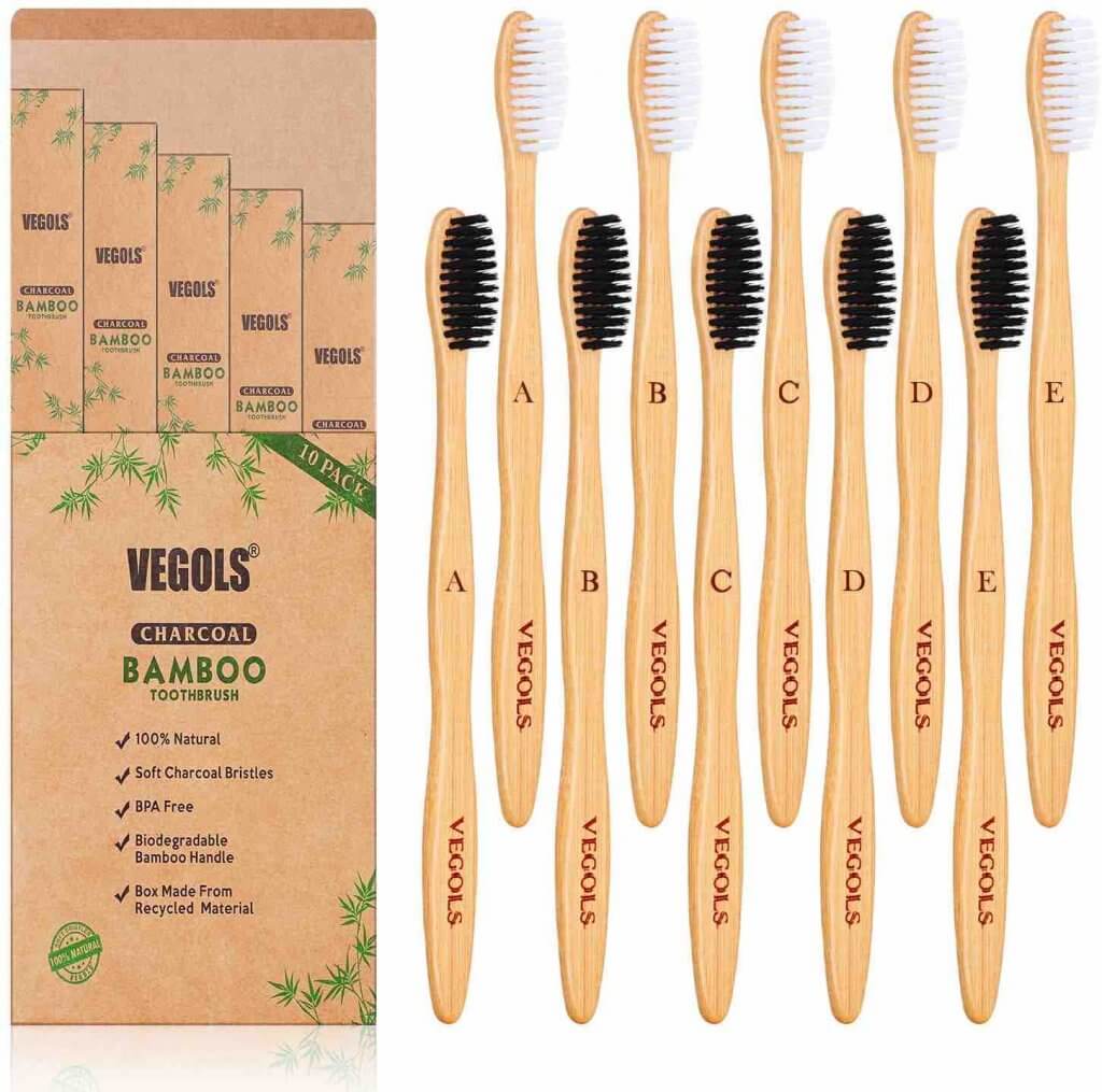 One of the best zero waste bathroom essentials are bamboo toothbrushes. Image of a set of charcoal bamboo toothbrushes by Vegols.