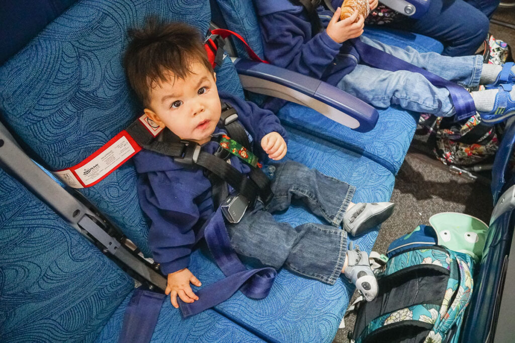 Image of a toddler using a CARES harness on an airplane