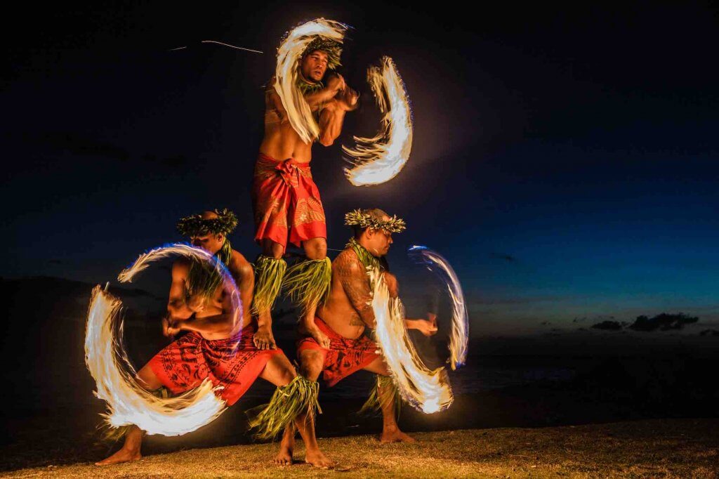 Get all your top Hawaii luau questions answered by top Hawaii blog Hawaii Travel with Kids.Image of Three Strong Men Juggling Fire in Hawaii - Fire Dancers.