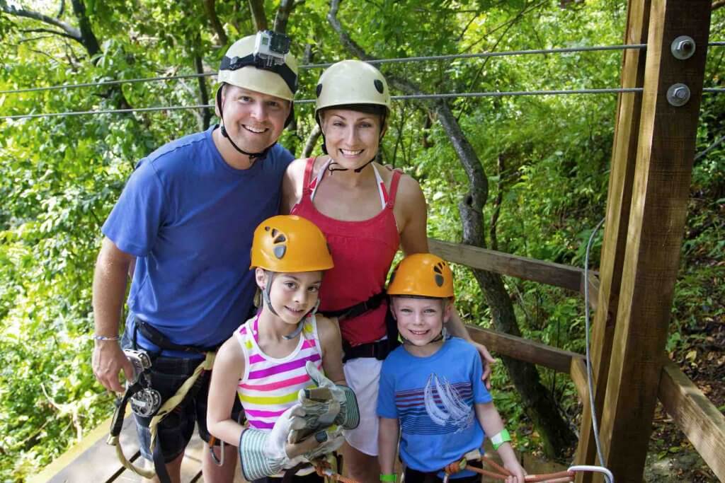 If you're visiting Hawaii for the first time, you might plan too many activities. Image of a family wearing helmets before ziplining in Hawaii.