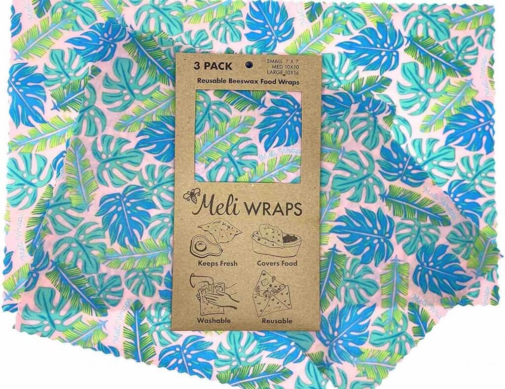 One of the most useful zero-waste essentials when it comes to food are these Meli Wraps made of beeswax. Image of a tropical leaf print reusable food wrap.