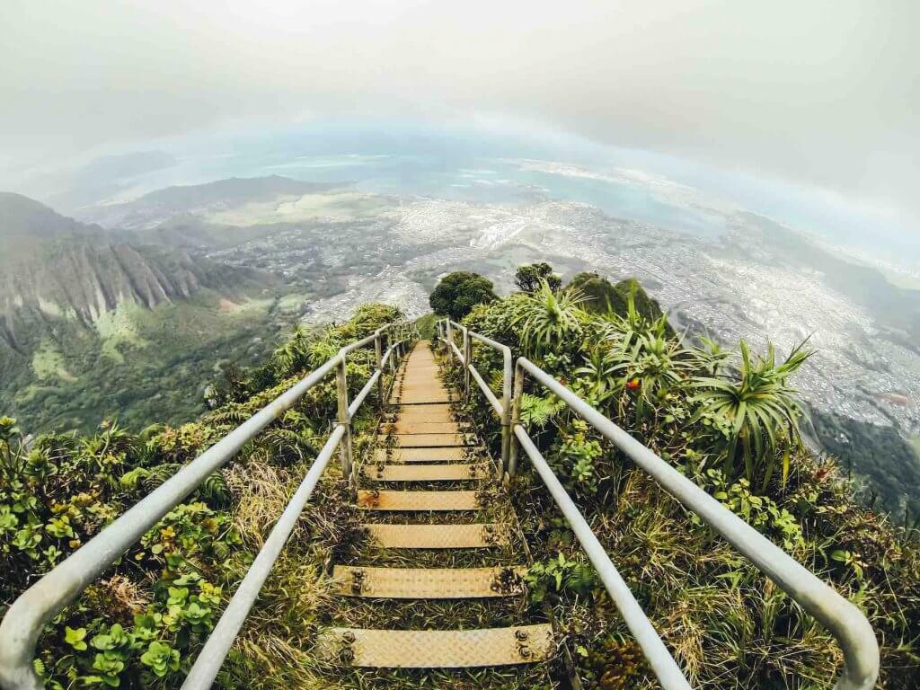 Don't hike the Stairway to Heaven (aka Haiku Stairs) on Oahu, Hawaii. Image of a staircase through the lush greenery of a Hawaii mountain.