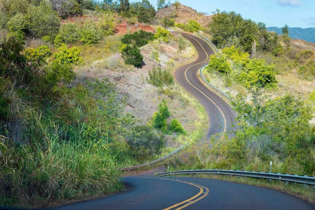 You might get car sick while driving to the Kalalau Lookout near Waimea Canyon on Kauai. Image of winding street to Kalalau Lookout on the Hawaiian island of Kauai, USA.