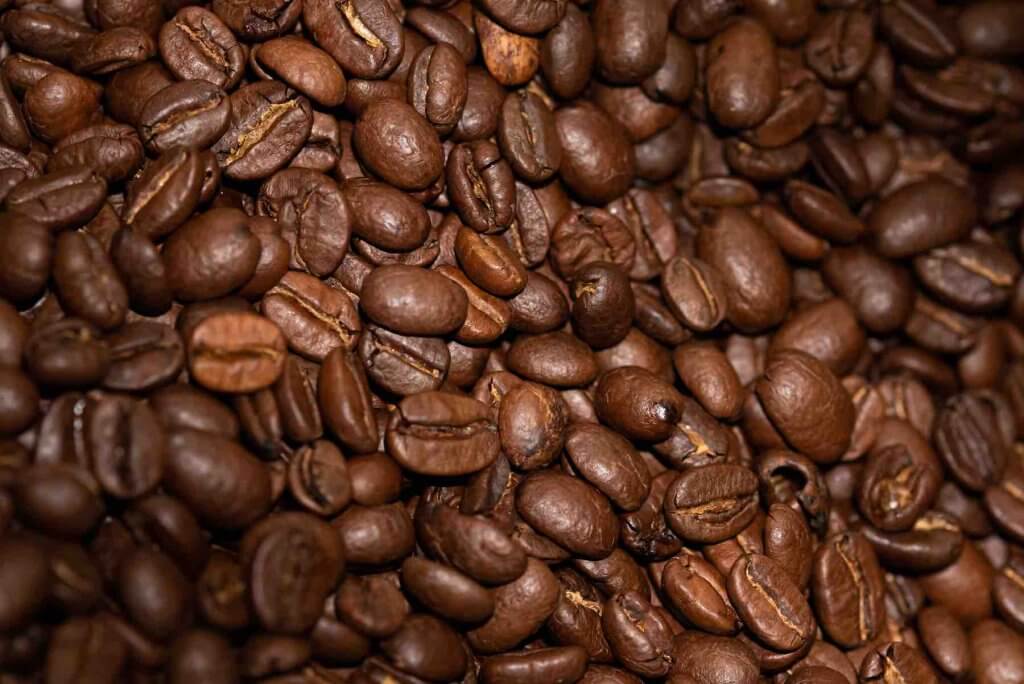 One of the best fun facts about Hawaii is that they are the only state that grows coffee to sell commercially. Image of a bunch of coffee beans.