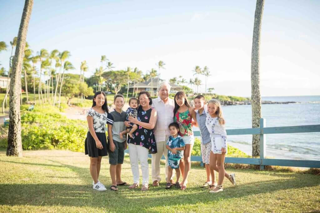 We love booking afforable Maui photographers when we do multigenerational travel. Image of grandparents with 7 grandkids in Hawaii.