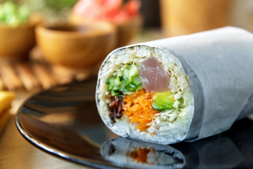 Check out this North Shore Kauai Food Tour review by top Hawaii blog Hawaii Travel with Kids. Image of a sushi burrito.