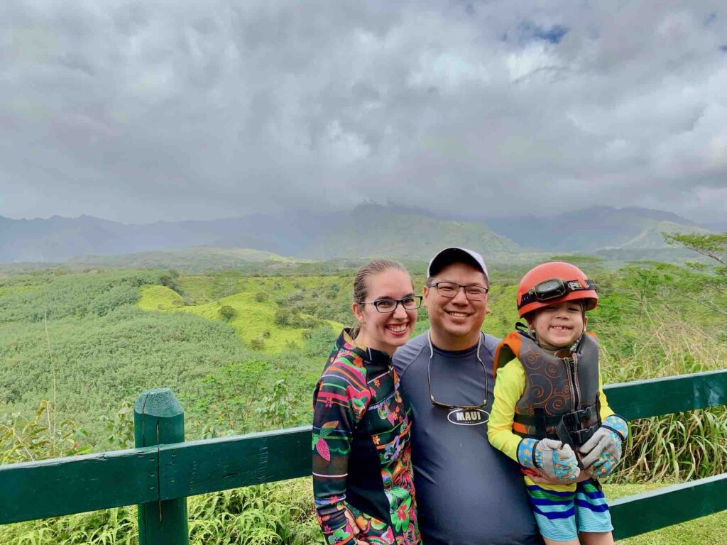 Image of a family posing at Mt. Waialeale on Kauai.