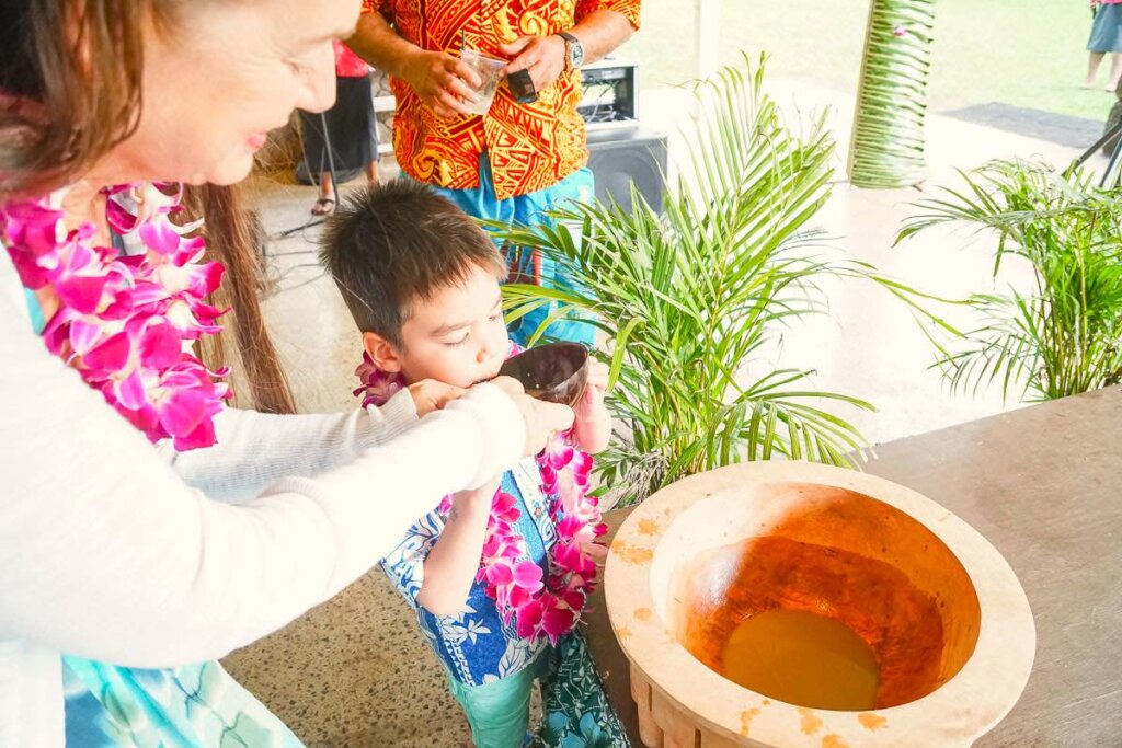 Toa luau is the best luau in Oahu North Shore that's intimate and affordable. Image of a boy trying kava at Toa Luau in Oahu.