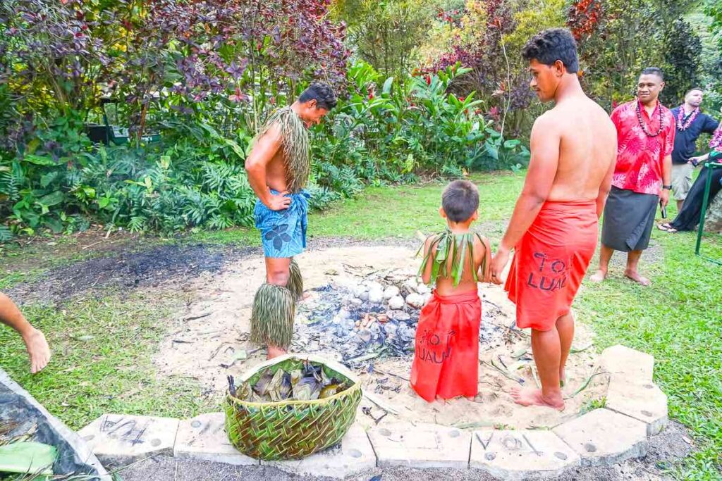 Most luaus on Oahu don't have as many hands on activities like Toa Luau in North Shore Oahu. Image of some men standing around a Samoan Umu oven ready to dig up the food.
