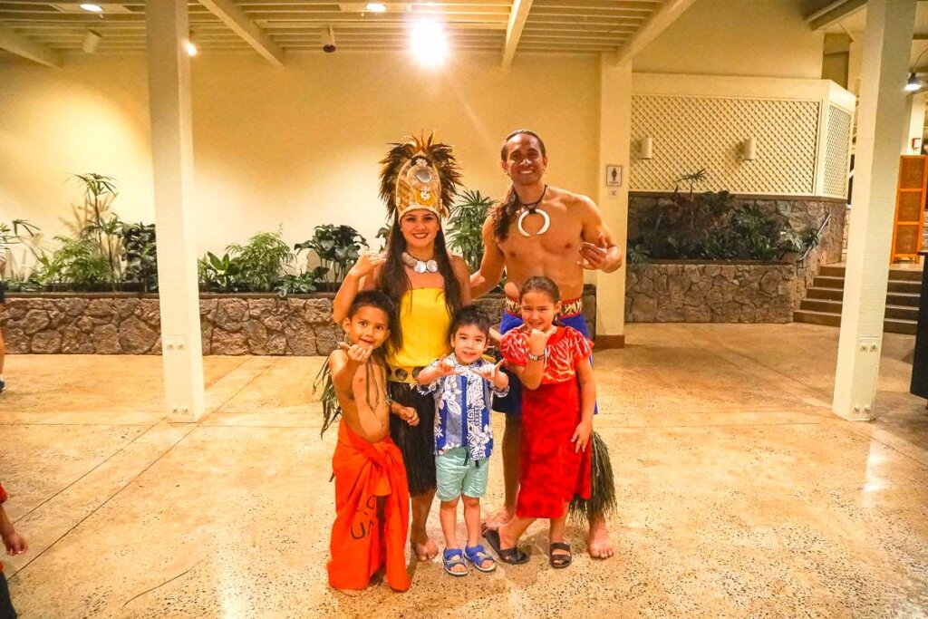 Image of a Samoan family posing with a little boy at a North Shore luau on Oahu.