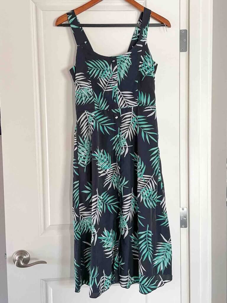 Image of a super cute green and black tropical print dress perfect for a Hawaii packing list.