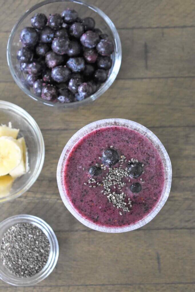 These are the ingredients you need to make this blueberry chia smoothie. Image of a bowl of blueberries, sliced banana, and chia seeds.