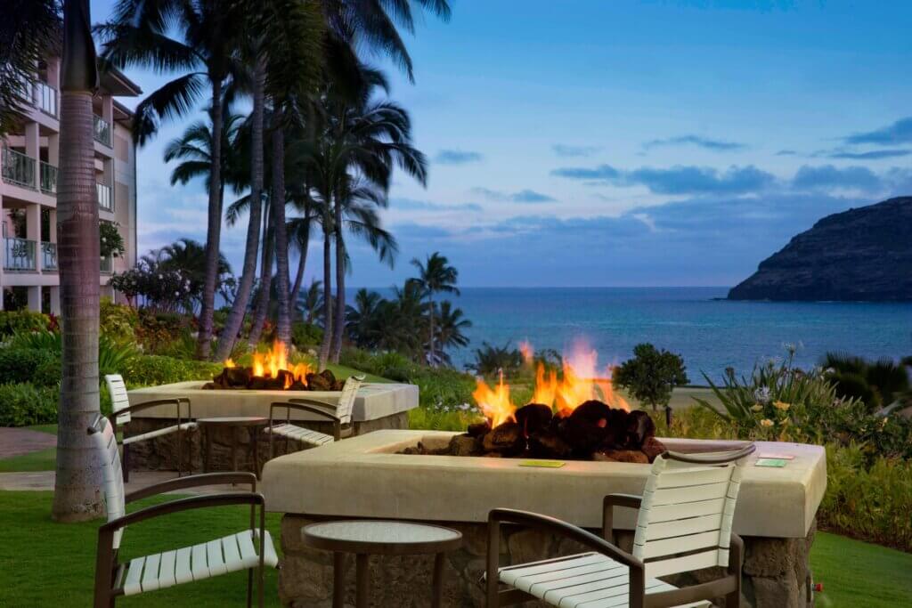 Marriott's Kauai Lagoons is one of the best resorts in Kauai for families who love a central location. Image of a fire pit overlooking the ocean.