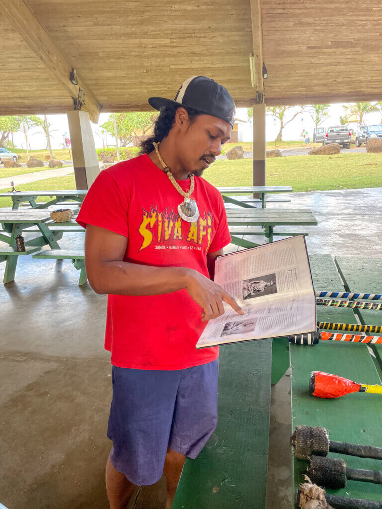 We learned a bit about Samona history and culture before this Polynesian fire dancing workshop. Image of a man reading from a book.