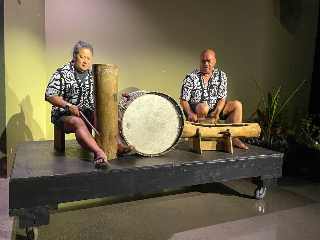 One of the Polynesian drummers at the Ahi Lele Fire Show on Kauai was from the famous Hawaiian band Hapa! Image of two musicians playing Polynesian drums.