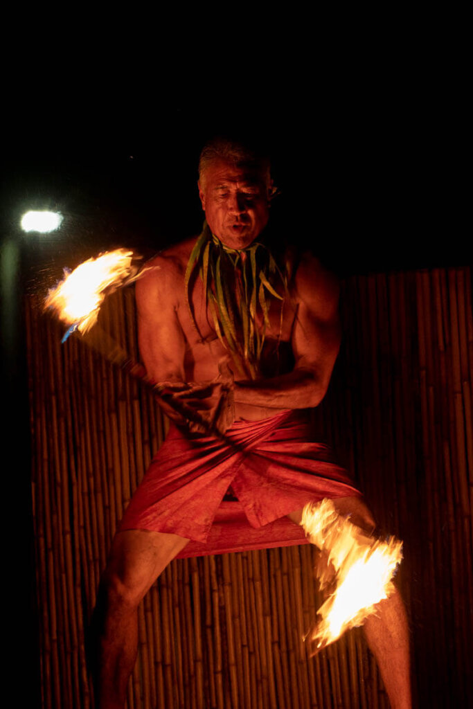 See amazing Hawaiian fire dancers at the Ahi Lele Fire Show, a new Kauai luau. Image of a man twirling fire in Hawaii.