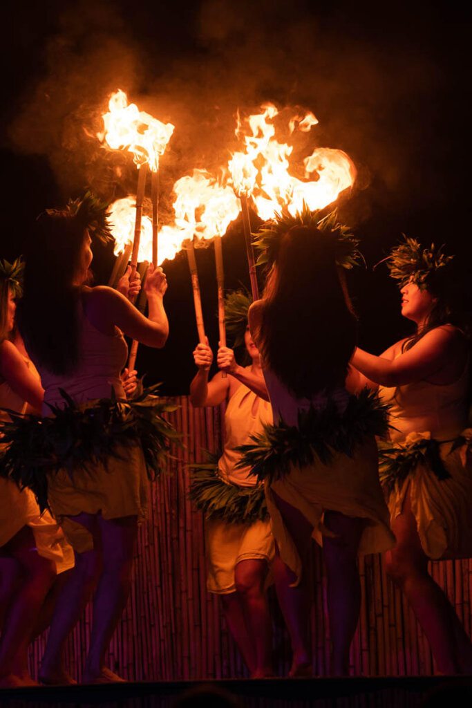 See Tahitian fire dancing at the Ahi Lele Fire Show on Kauai. Image of Tahitian dancers holding torches while dancing in a circle.