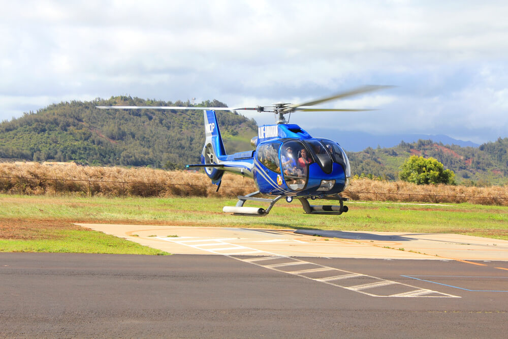 Find out the best things to do in Lihue Kauai recommended by top Hawaii blog Hawaii Travel with Kids. Image of a helicopter at Lihue Airport on Kauai.