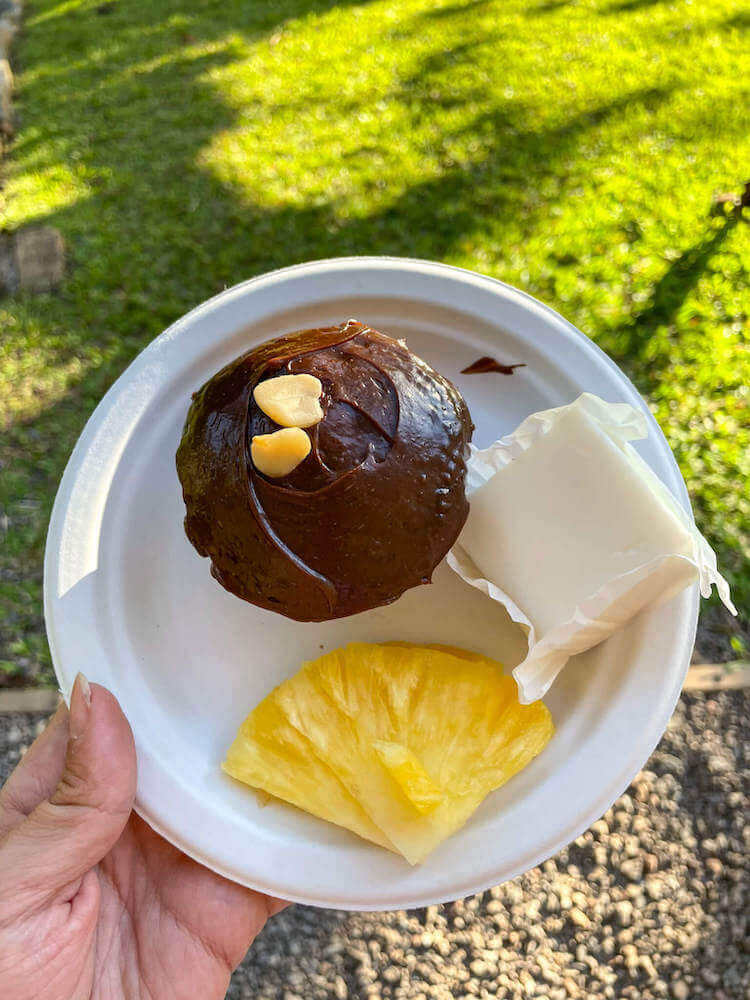 Try some tasty Hawaiian desserts at Nutridge Luau on Oahu. Image o a chocolate cupcake, haupia, and slice of pineapple.