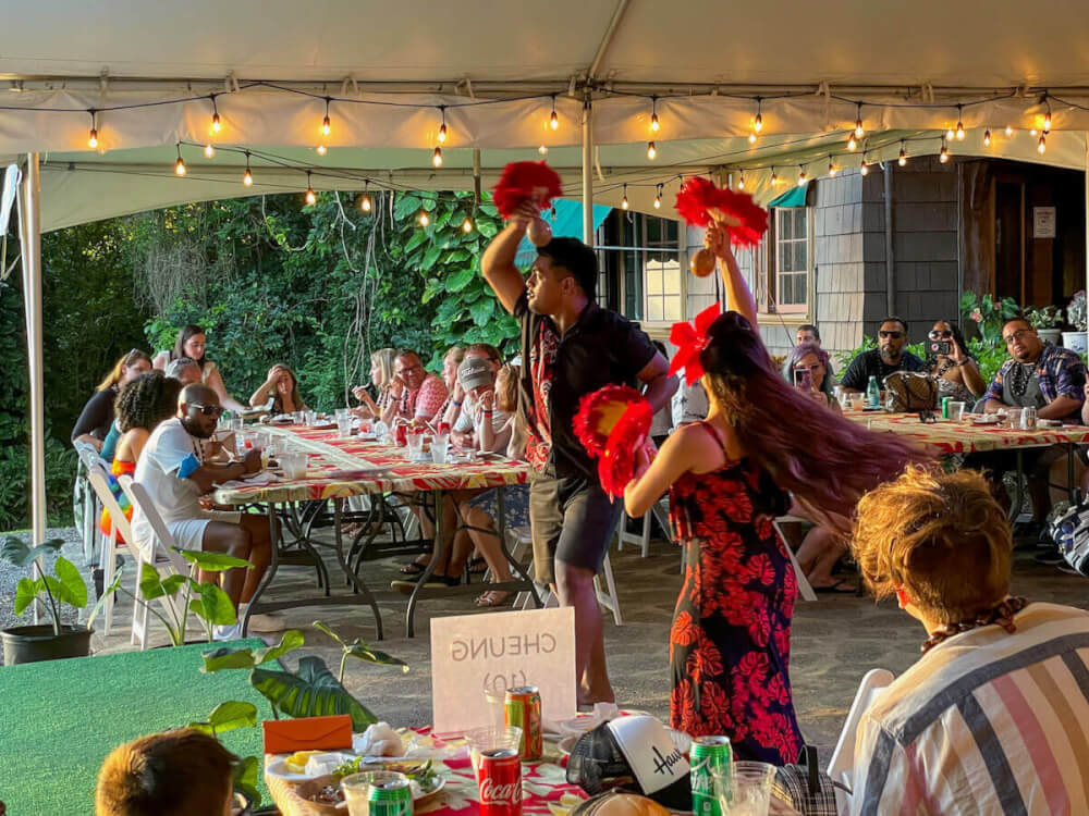 Image of a man and woman dancing hula at a luau in Honolulu.