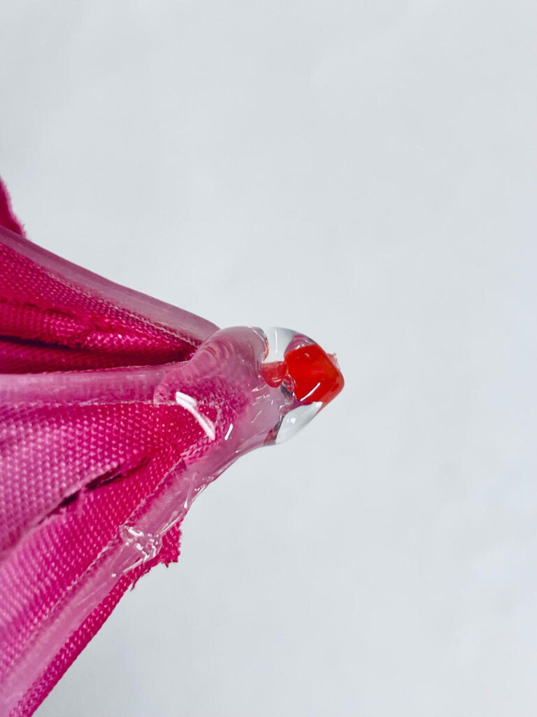 Image of hot glue on a pink silk flower.