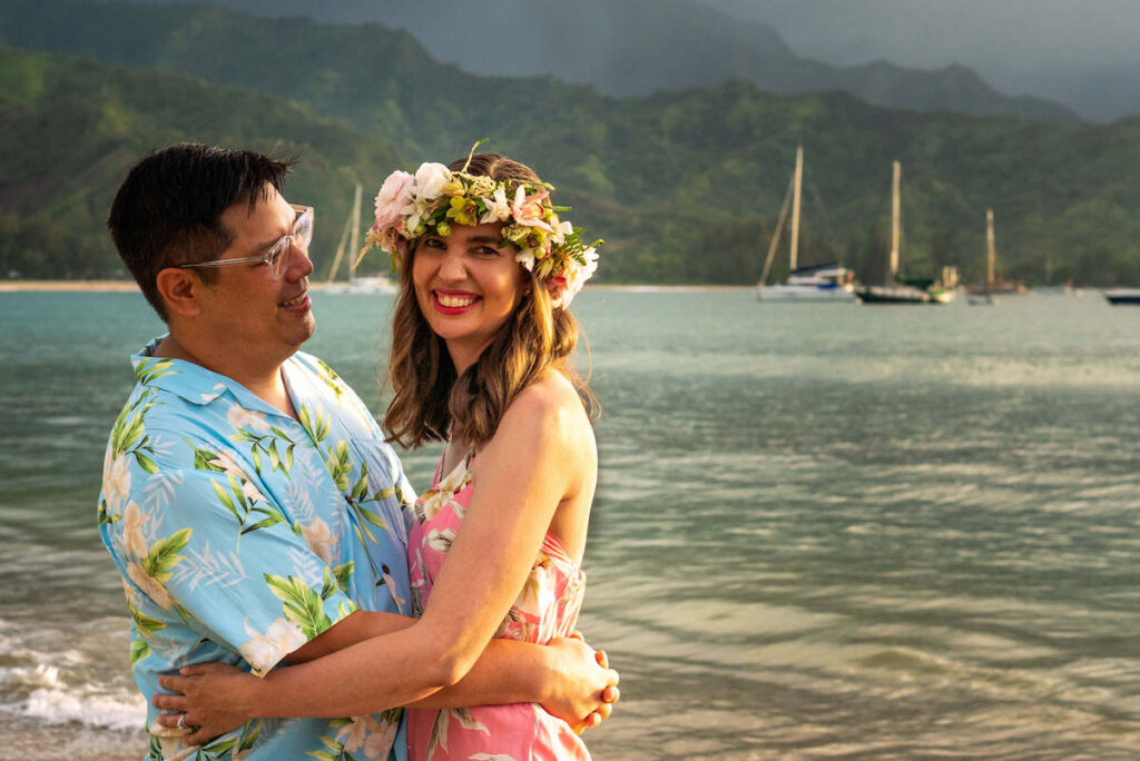 Make sure to get a few "couple shots" during your Hawaii photographer shoot. Image of a man and woman embracing on a Kauai beach.