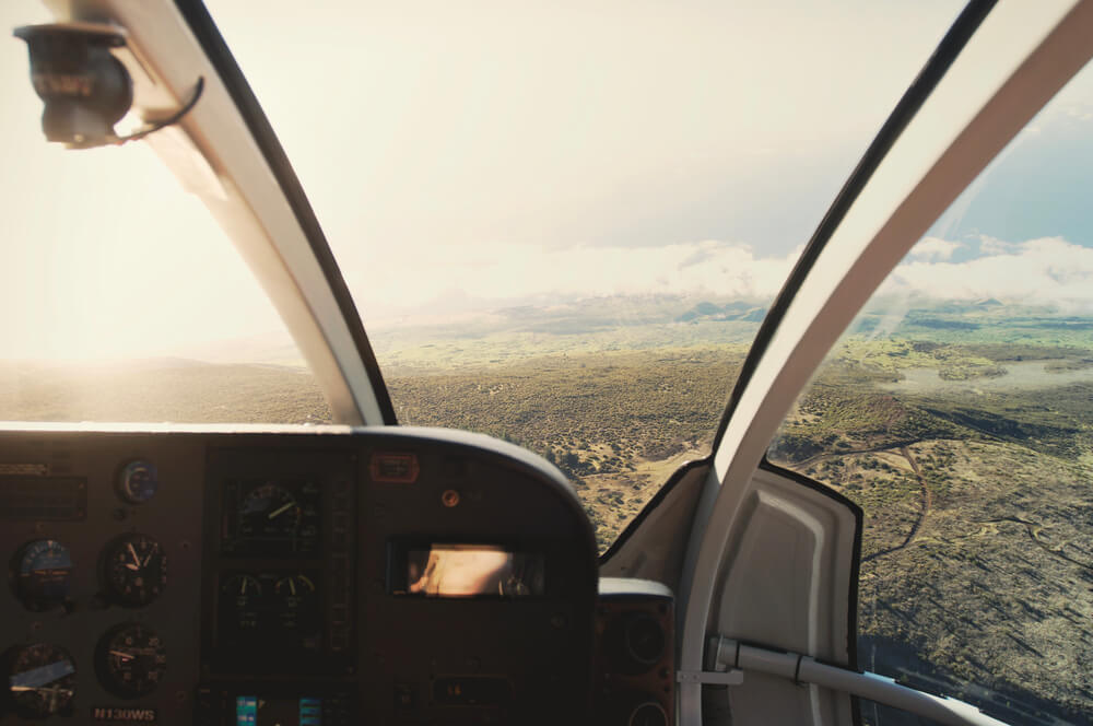 One of the best Haleakala tours is a thrilling Maui helicopter tour. Image of a the inside of a helicopter flying over Maui Hawaii.