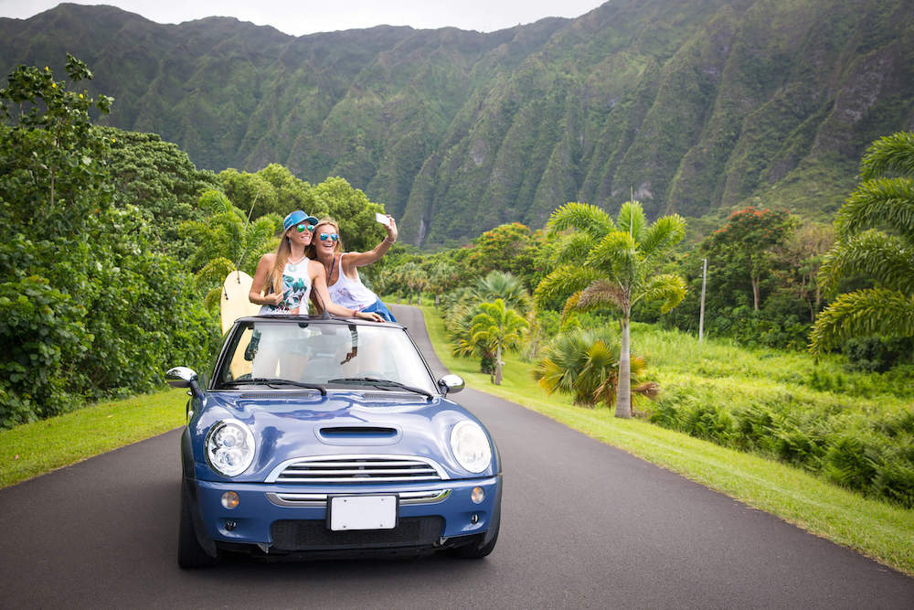 Find out the best Hawaii captions for Instagram by top Hawaii blog Hawaii Travel with Kids. Image of two women taking a selfie at Ho'omaluhia Botanical Garden on Oahu Hawaii.