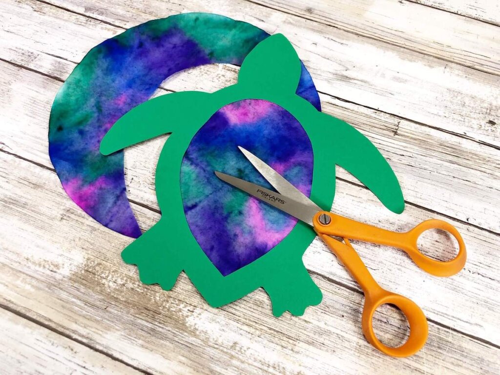 Learn how to make a sea turtle suncatcher paper craft by top Hawaii blog Hawaii Travel with Kids. Image of a sea turtle paper craft.
