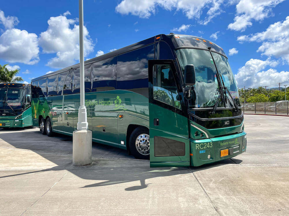 Hop on the free Pearl Harbor shuttle that takes you to all the Pearl Harbor Attractions, including the USS Battleship Missouri. Image of a green Roberts Hawaii tour bus.