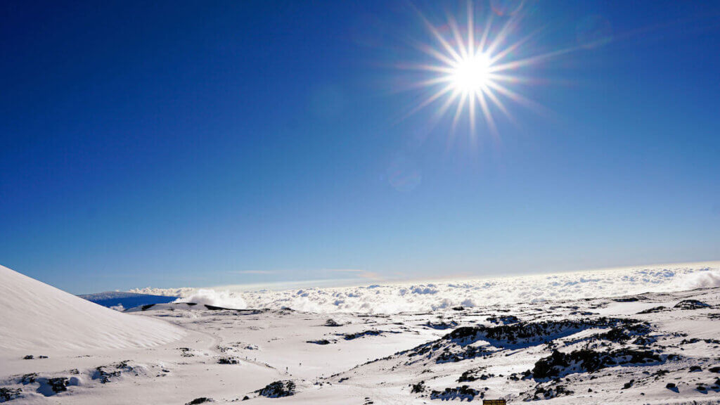 Find out how to go skiing in Hawaii by top Hawaii blog Hawaii Travel with Kids. Image of snow at Mauna Kea on the Big Island of Hawaii.